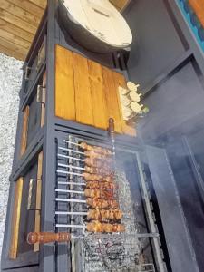 a grill with a bunch of food cooking on it at Laguna Relax in Balqash