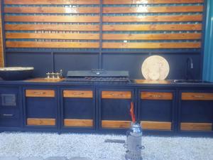 a kitchen with a counter with wooden cabinets at Laguna Relax in Balqash +5 photos