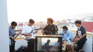 a group of people playing music and playing guitars at Azul Berg Hostel in Tamraght Ouzdar