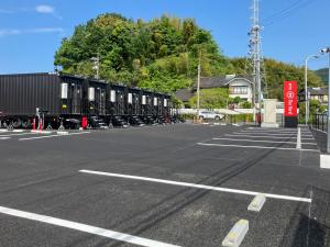 a row of train cars parked in a parking lot at HOTEL R9 The Yard Hikari in Hikari +18 photos