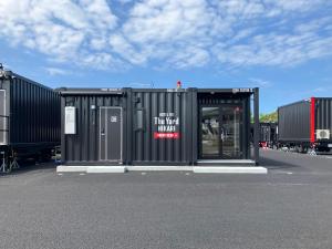 a large black building with a sign on it at HOTEL R9 The Yard Hikari in Hikari