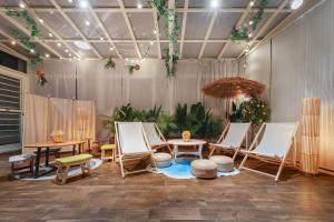 a room with chairs and tables and an umbrella at Penghu Story Teller Easy Stay in Magong
