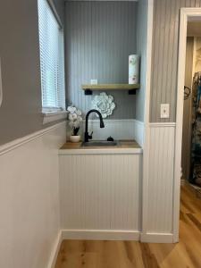a kitchen counter with a sink and a window at Berlins Cozy Apartment Pets Welcome in North Little Rock
