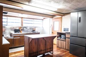 a kitchen with wooden cabinets and a large island at 白灯-Hakuto- Muikamachi in Minami Uonuma