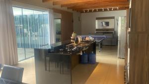 a kitchen with a large island in the middle at Lar com piscina in Primavera do Leste
