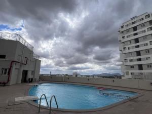 a large swimming pool on the roof of a building at Beruru Homes- 2BHK Apartment near Bengaluru Airport in Devanhalli