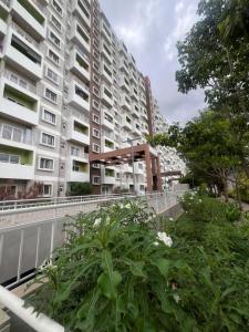 an apartment building with a garden in front of it at Beruru Homes- 2BHK Apartment near Bengaluru Airport in Devanhalli