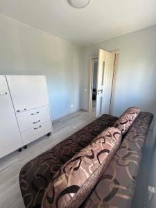 a bedroom with a large bed and a dresser at 3 kambarai in Naujoji Akmenė