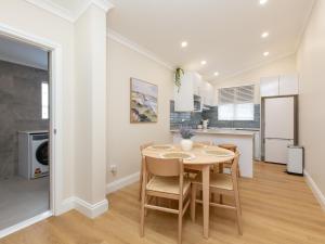a kitchen and dining room with a table and chairs at The Clifton Motel in Bunbury
