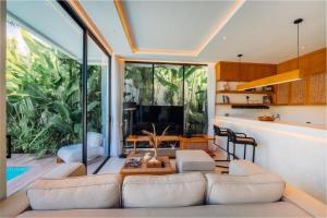 a living room with a couch and a tv at Candidasa Hills in Candidasa