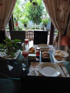 a black table with plates of food and glasses of wine at Idor Holidays in Sri Jayewardenepura Kotte +18 photos