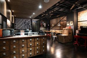 a room with a television and a table with chairs at P&F Hotel in Taichung