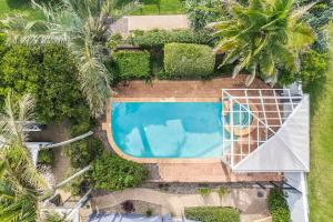 an overhead view of a swimming pool with palm trees at Coolum Beach Apartment, 2 Bed 2 Bath, Pool in Coolum Beach