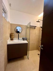 a bathroom with a sink and a mirror at Villa Patria in Calatagan