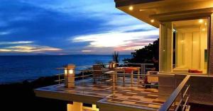 a balcony of a house with a view of the ocean at Casa Bahia Dive Resort in Mabini