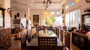 a restaurant with chairs and a glass table in a room at Casa Bahia Dive Resort in Mabini