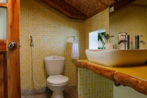a bathroom with a toilet and a sink at Oceanside Villa in Puerto Galera +30 photos