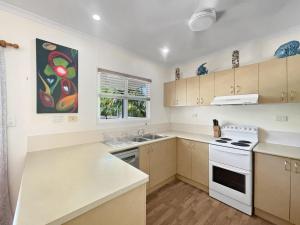 a kitchen with white appliances and a painting on the wall at Gigi's Getaway in Horseshoe Bay