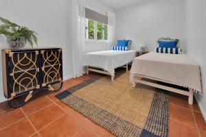 a room with two beds and a window at Birdwing Retreat in Picnic Bay +5 photos