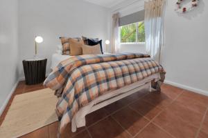 a bedroom with a bed and a window at Birdwing Retreat in Picnic Bay