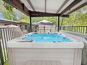 a hot tub on a deck with a fence at Alma Rocks in Arcadia