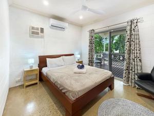 a bedroom with a bed and a balcony at Runswick in Horseshoe Bay