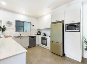 a kitchen with white cabinets and a yellow refrigerator at Runswick in Horseshoe Bay