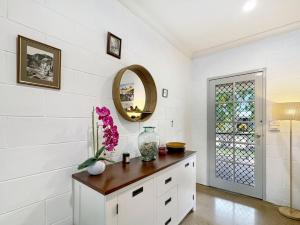a white room with a table with a vase on it at Runswick in Horseshoe Bay