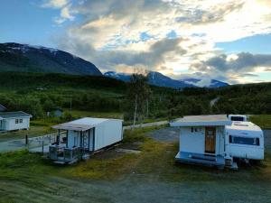 a couple of rvs parked in a parking lot at Øse Camping in Gratangen