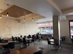 a restaurant with tables and chairs and a stone wall at Queens Head Hotel in West Hobart +7 photos
