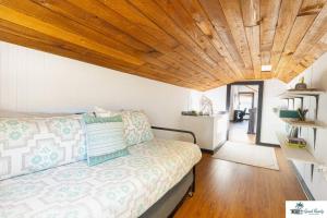 a bedroom with a bed and a wooden ceiling at Waterfront Zen-Dock, Paddleboards, Jacuzzi & Games in St. Augustine