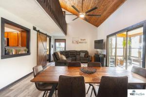 a living room with a table and a couch at Waterfront Zen-Dock, Paddleboards, Jacuzzi & Games in St. Augustine