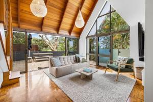 a living room with a couch and a table at Salt Luxury Location in Sunshine Beach +30 photos