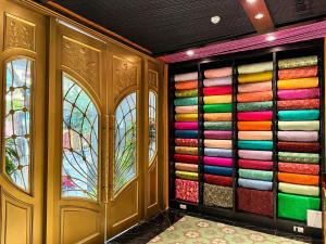 a room with a wall full of colorful towels at Loom Hotel Hanoi in Hanoi