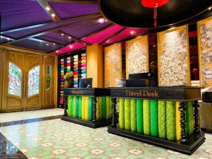 a travel desk in a hotel lobby with colorful walls at Loom Hotel Hanoi in Hanoi