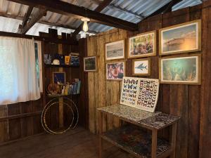 a room with wooden walls with pictures and a shelf at Donde Sergio - Acantilados in Buenaventura