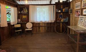 a room with wooden walls and a window and chairs at Donde Sergio - Acantilados in Buenaventura +3 photos
