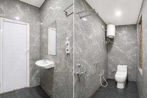 a bathroom with a shower and a toilet and a sink at Hotel Philips in Kolkata +30 photos