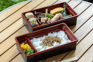 two containers of sushi and rice on a table at Fairfield by Marriott Mie Okuise Odai in Odaicho