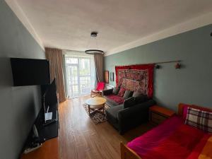 a living room with a couch and a table at Russian Embassy Apartment in Ulaanbaatar