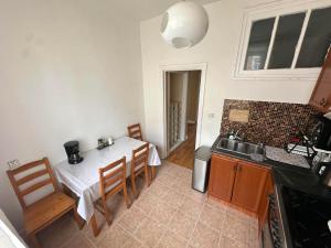 a kitchen with a table and chairs and a sink at Russian Embassy Apartment in Ulaanbaatar