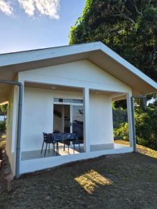 a large white garage with a table and chairs at Fare Hanihau in Uturoa