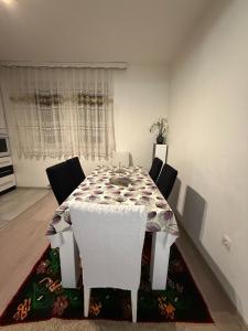 a white dining room table with white chairs and a tablecloth at Villa Calypso Sarajevo in Sarajevo +7 photos
