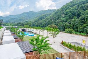 a resort with a swimming pool and mountains in the background at The Cliff Caravan Camping in Pocheon