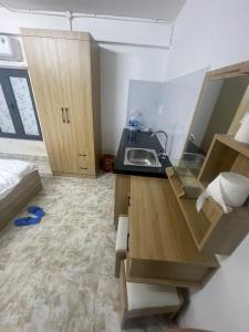 a small kitchen with a sink and a bed at Lami House in Danang +13 photos