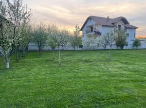 a house in a field with trees in front of it at Villa Calypso Sarajevo in Sarajevo