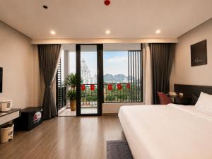 a hotel room with a bed and a balcony at Coline Hotel & Aparment in Ninh Binh +20 photos
