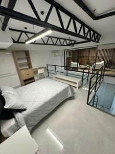 a bedroom with a bed and a chair in it at Moderno loft en el oeste in Cali +17 photos