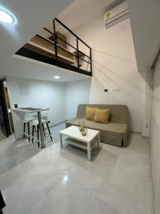 a living room with a couch and a table at Moderno loft en el oeste in Cali