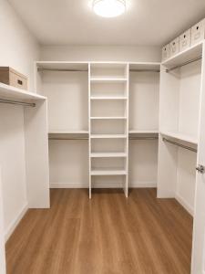 an empty room with white closets and wooden floors at Glendale Luxe Stays - Downtown in Glendale +22 photos